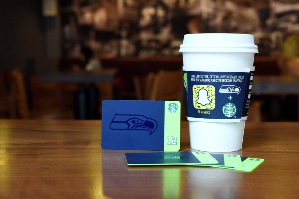 a coffee cup and credit cards on a table